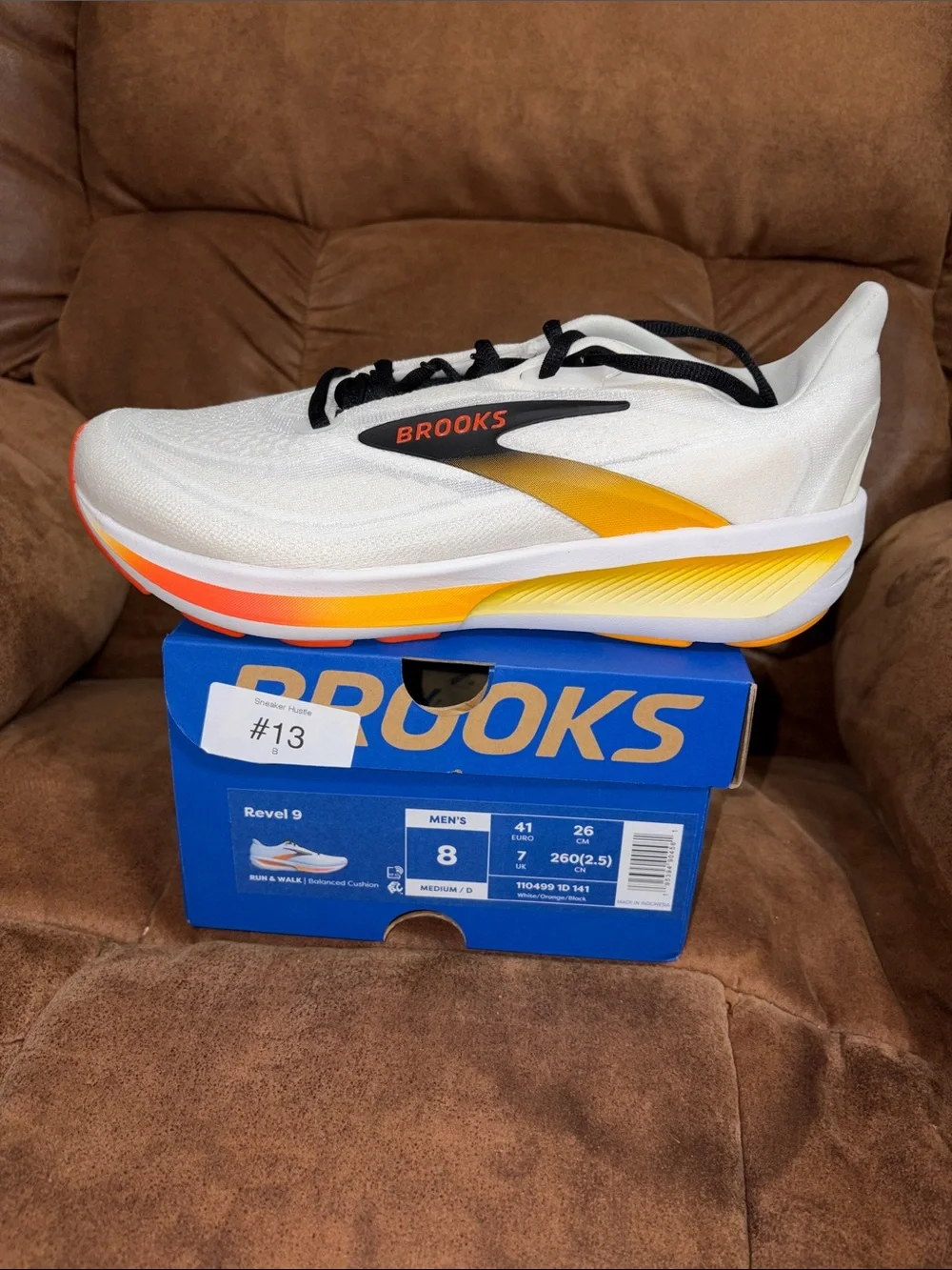 Brooks Revel 9 Men’s Running Shoe in White with Black, Yellow & Orange Accents